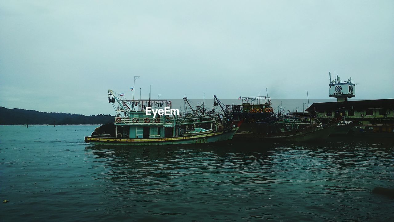 FISHING BOAT ON SEA AGAINST SKY