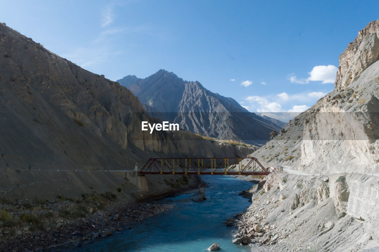 Overpass crossing over mountain river valley on a background of hills. kaza himachal pradesh india 