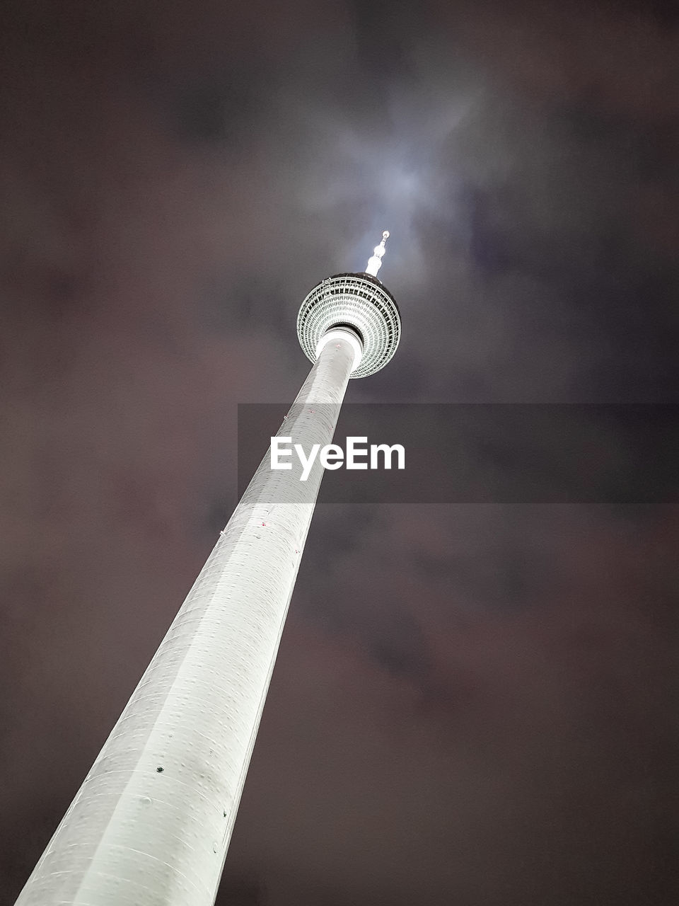 LOW ANGLE VIEW OF ILLUMINATED TOWER AGAINST SKY