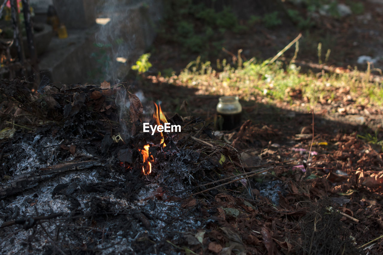 HIGH ANGLE VIEW OF BURNING FIRE ON FIELD