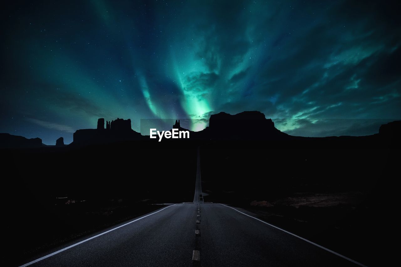 Scenic view of road against sky at night