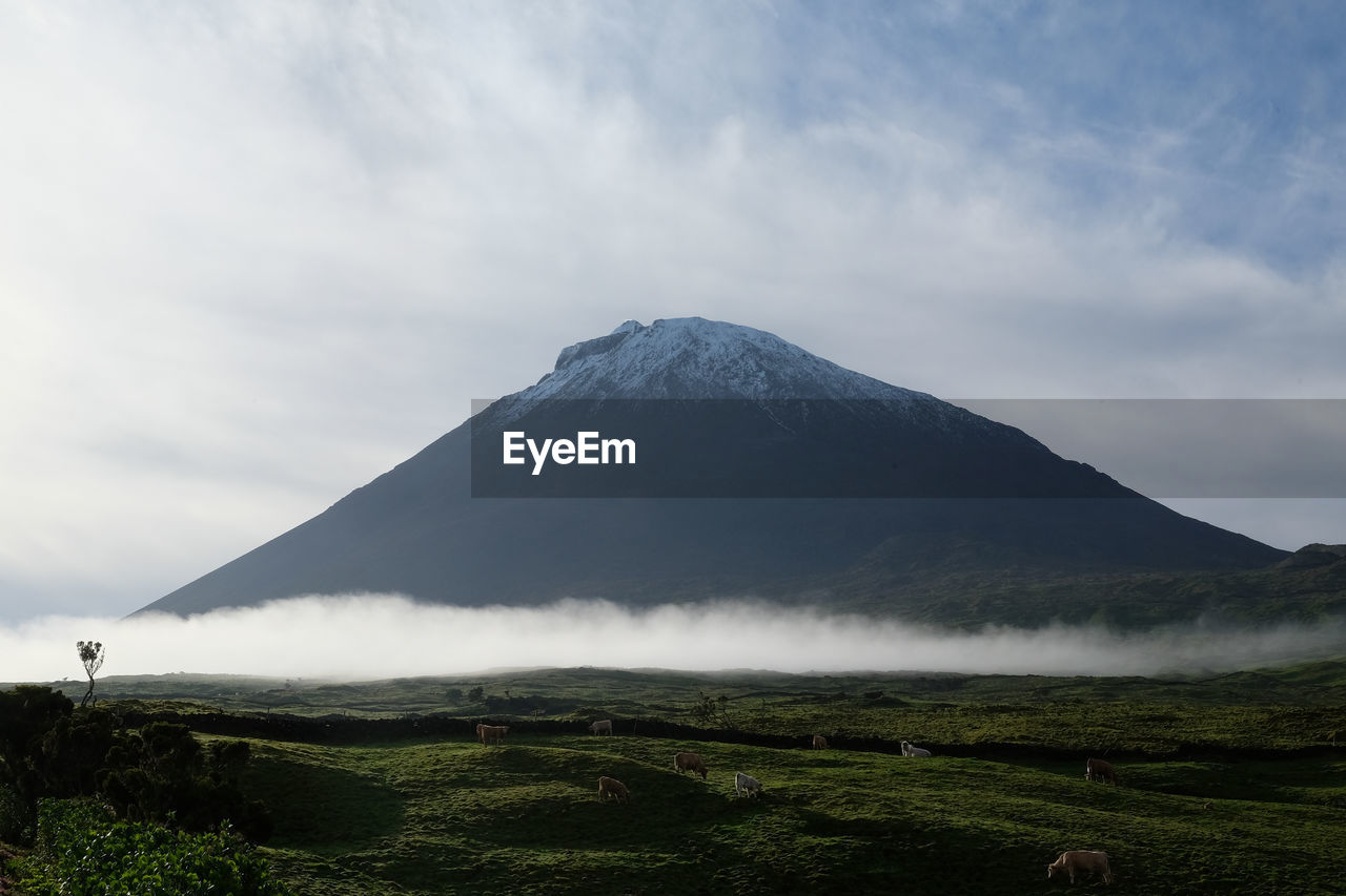 View of volcanic landscape against cloudy sky