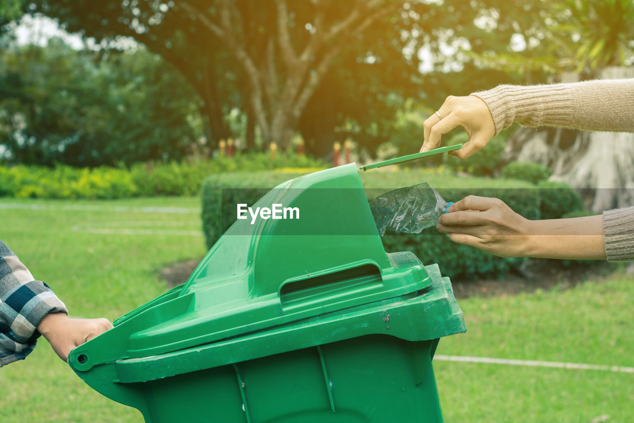 Hand holding dustbin