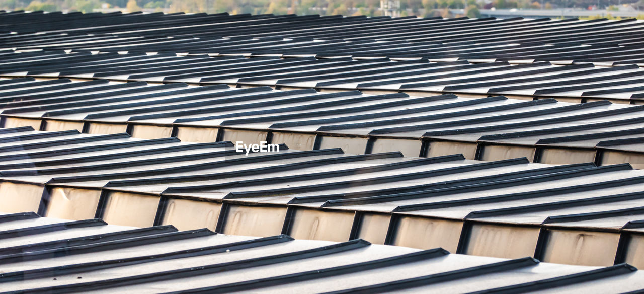 Detail view of a roof of a high-rise building with aluminium profiles as roof covering