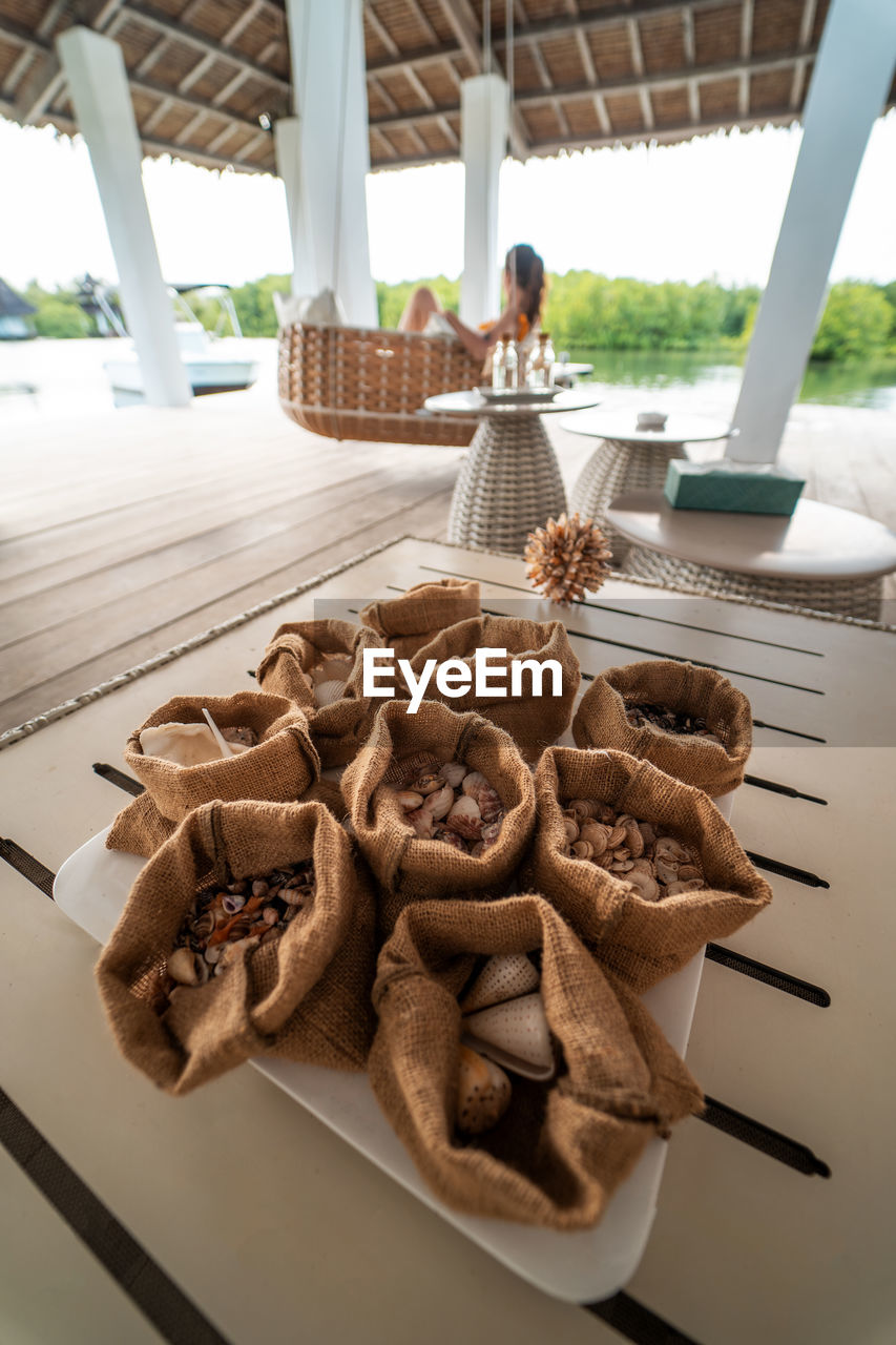 High angle view of sea shells in sack on table