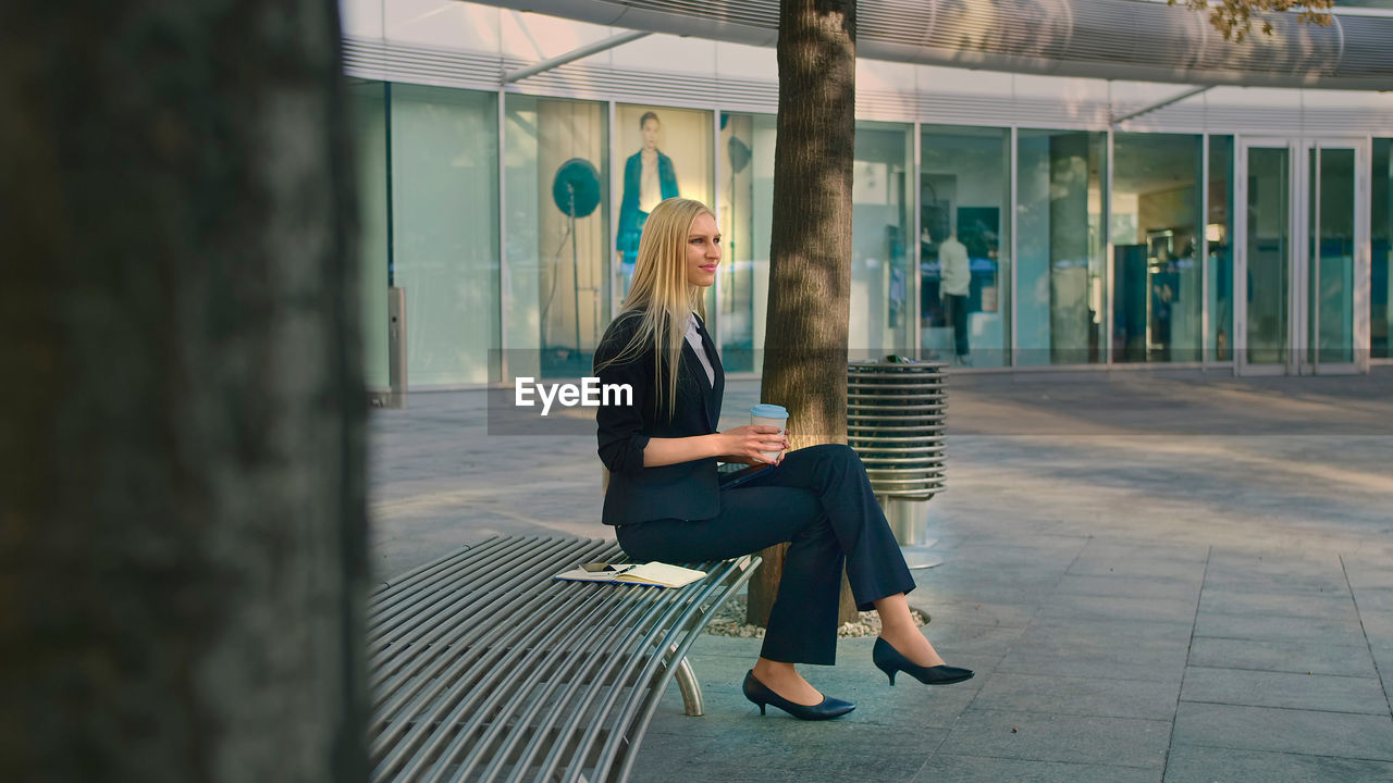 rear view of woman sitting on steps