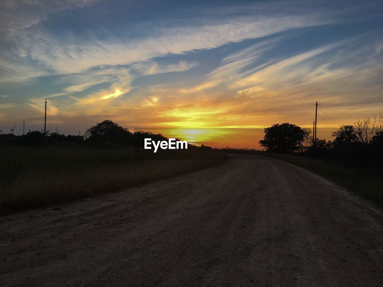 ROAD AGAINST SKY AT SUNSET