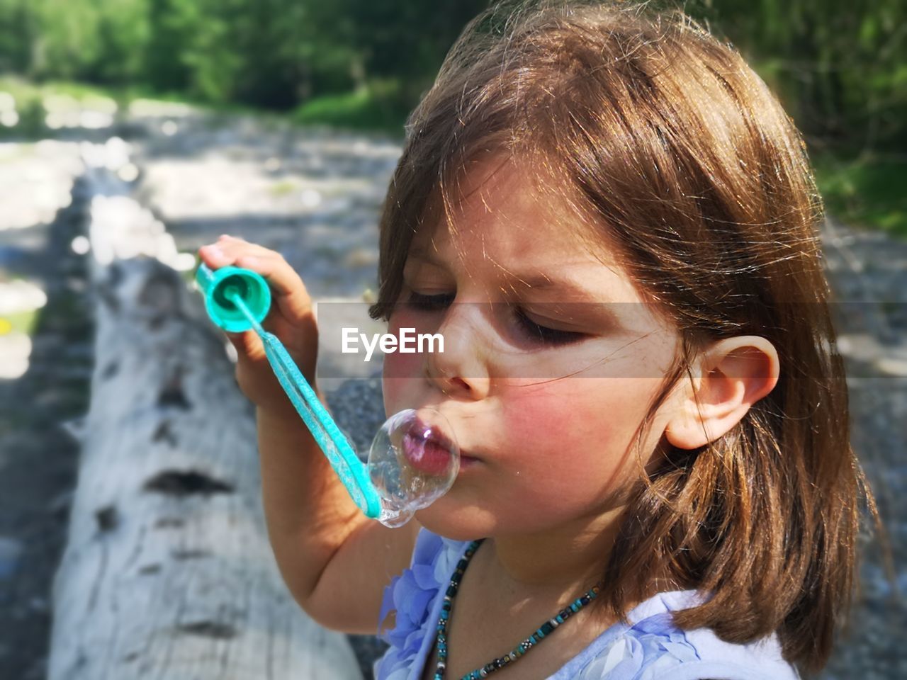 Close-up of girl blowing bubbles