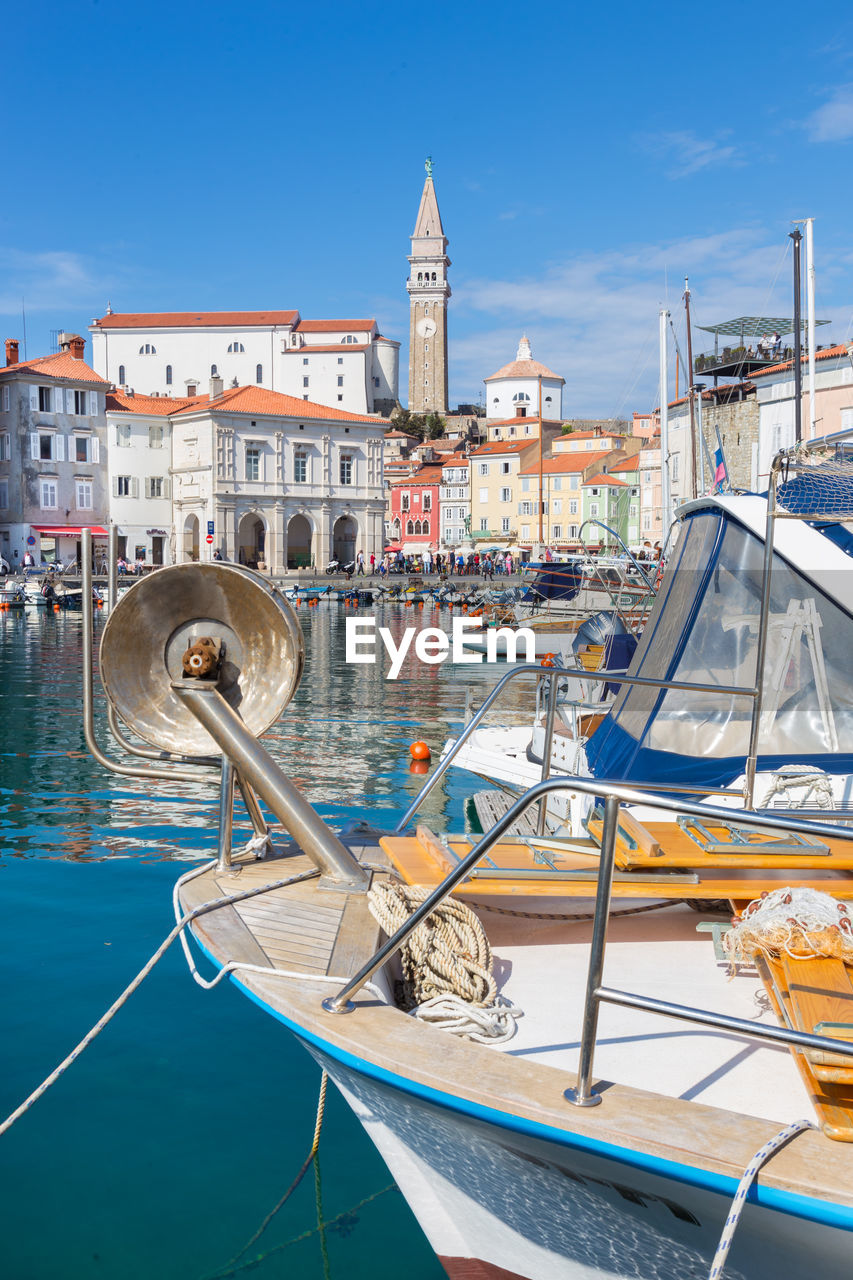 SAILBOATS MOORED IN HARBOR