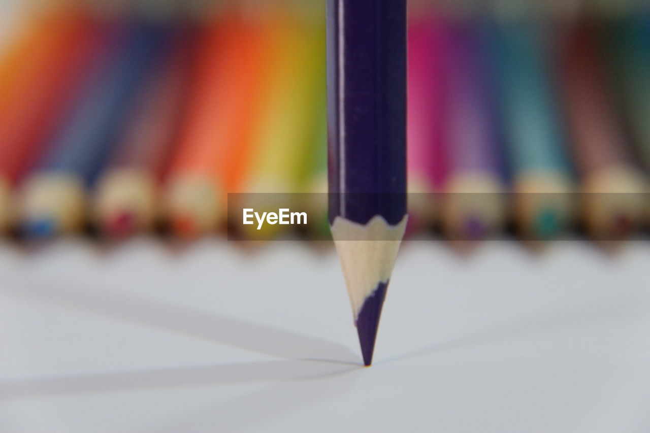 CLOSE-UP OF MULTI COLORED PENCILS ON SHELF