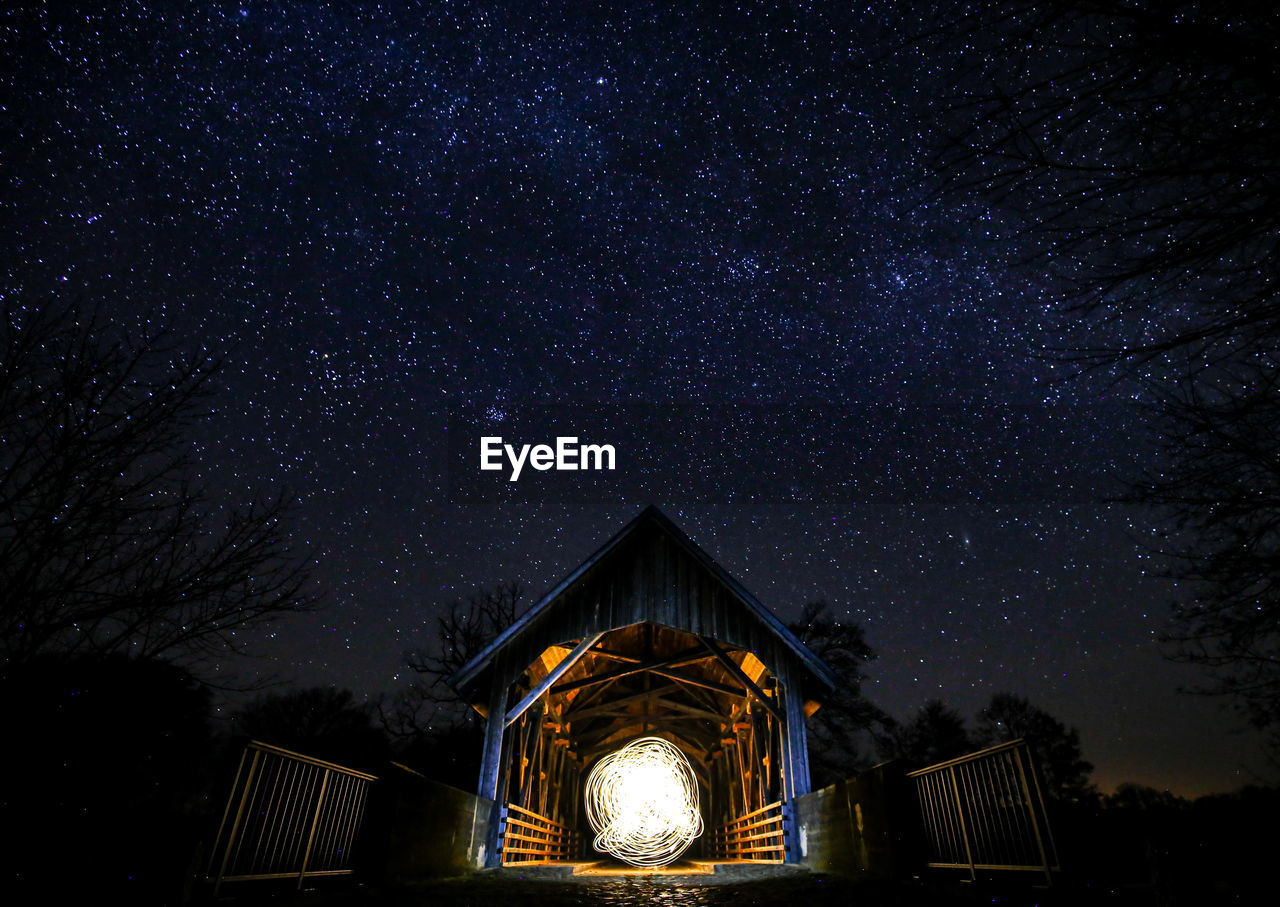 Low angle view of illuminated building against sky at night