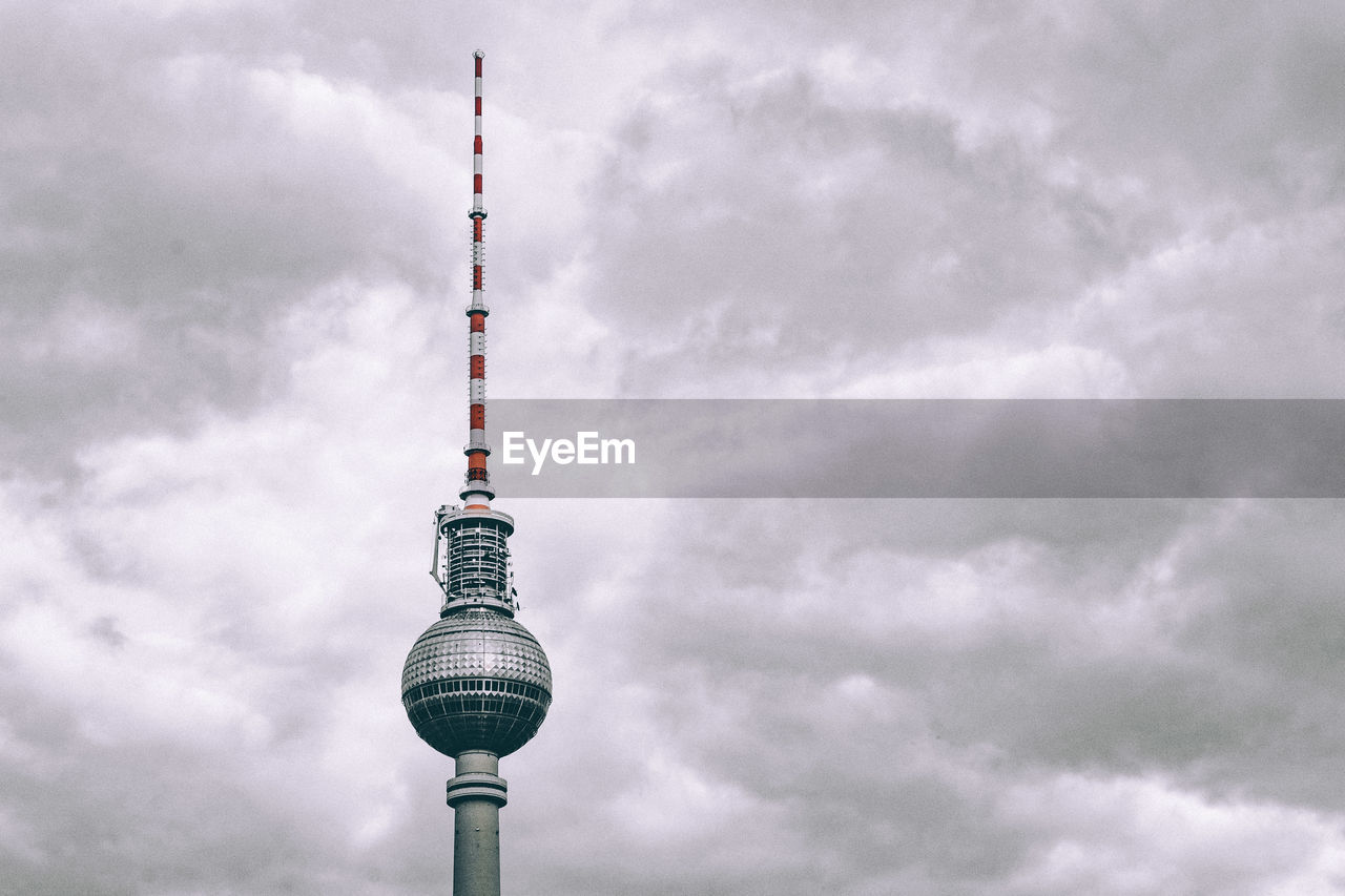 Television tower against cloudy sky