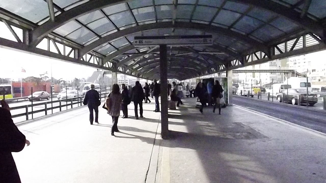 PEOPLE WAITING AT RAILROAD STATION PLATFORM