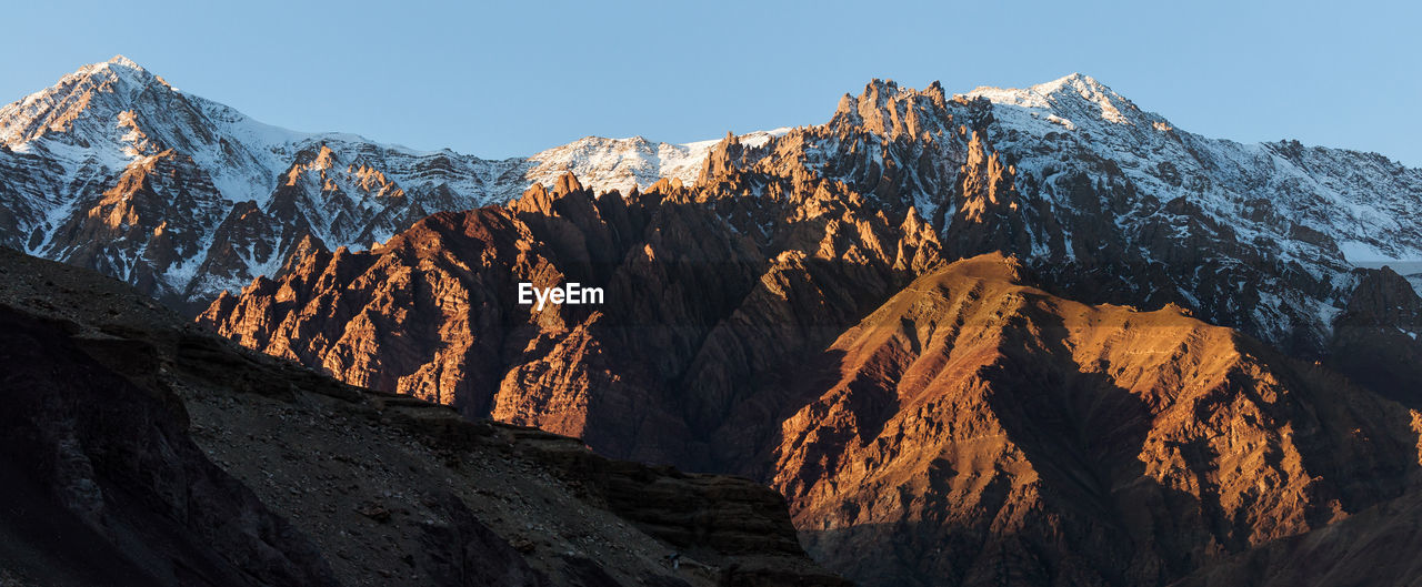 Scenic view of snowcapped mountains against clear sky