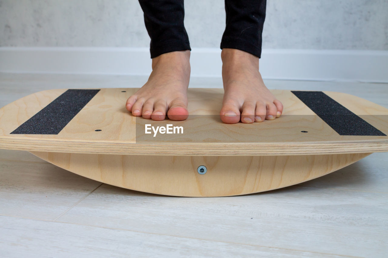 Low section of woman on balance board