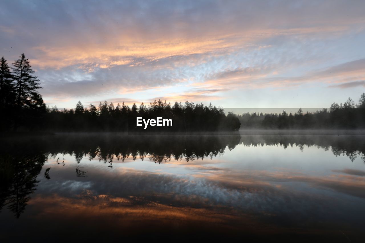 Scenic view of lake against sky during sunset