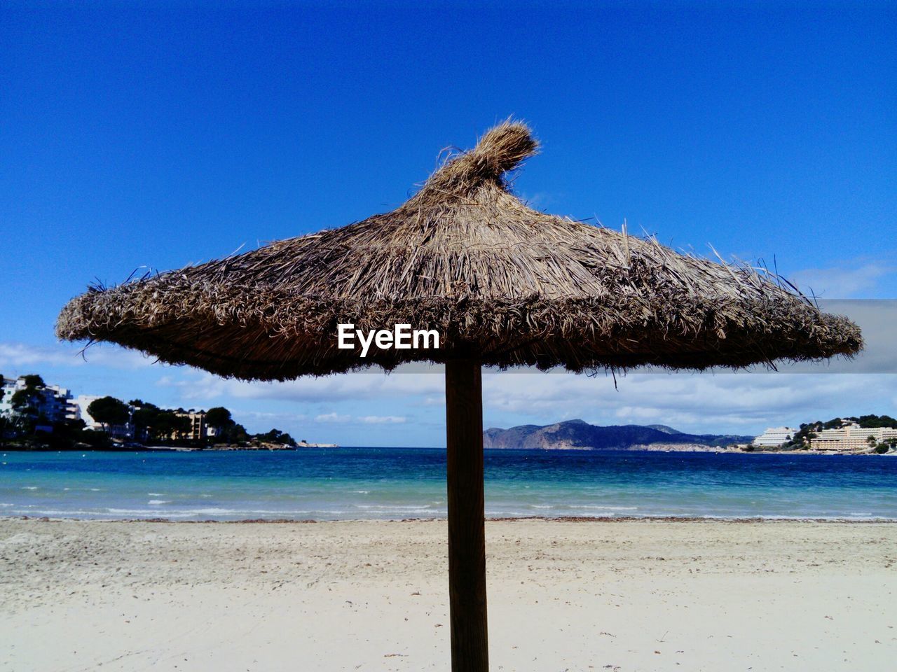 thatched roof, sea, sky, water, land, roof, beach, scenics - nature, nature, tranquility, tranquil scene, blue, beauty in nature, no people, day, clear sky, horizon, horizon over water, outdoors, coconut palm tree