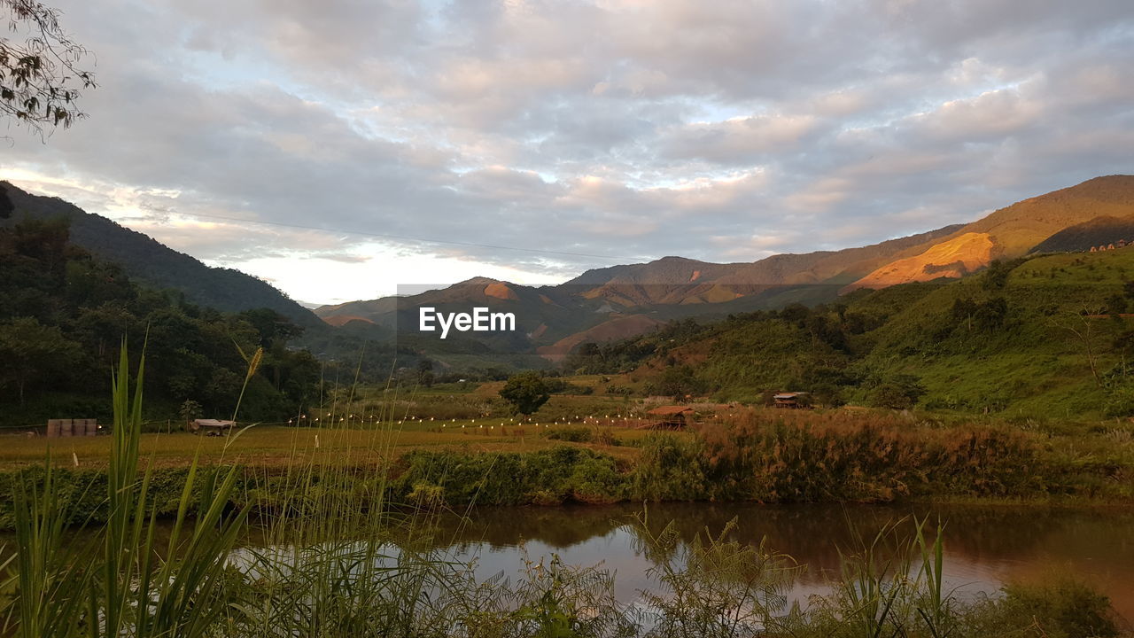 Scenic view of lake and mountains against sky