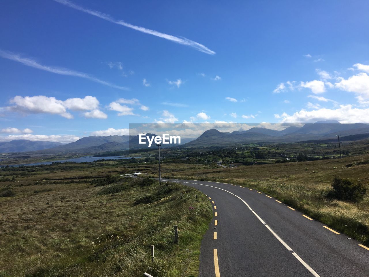 Road amidst landscape against sky