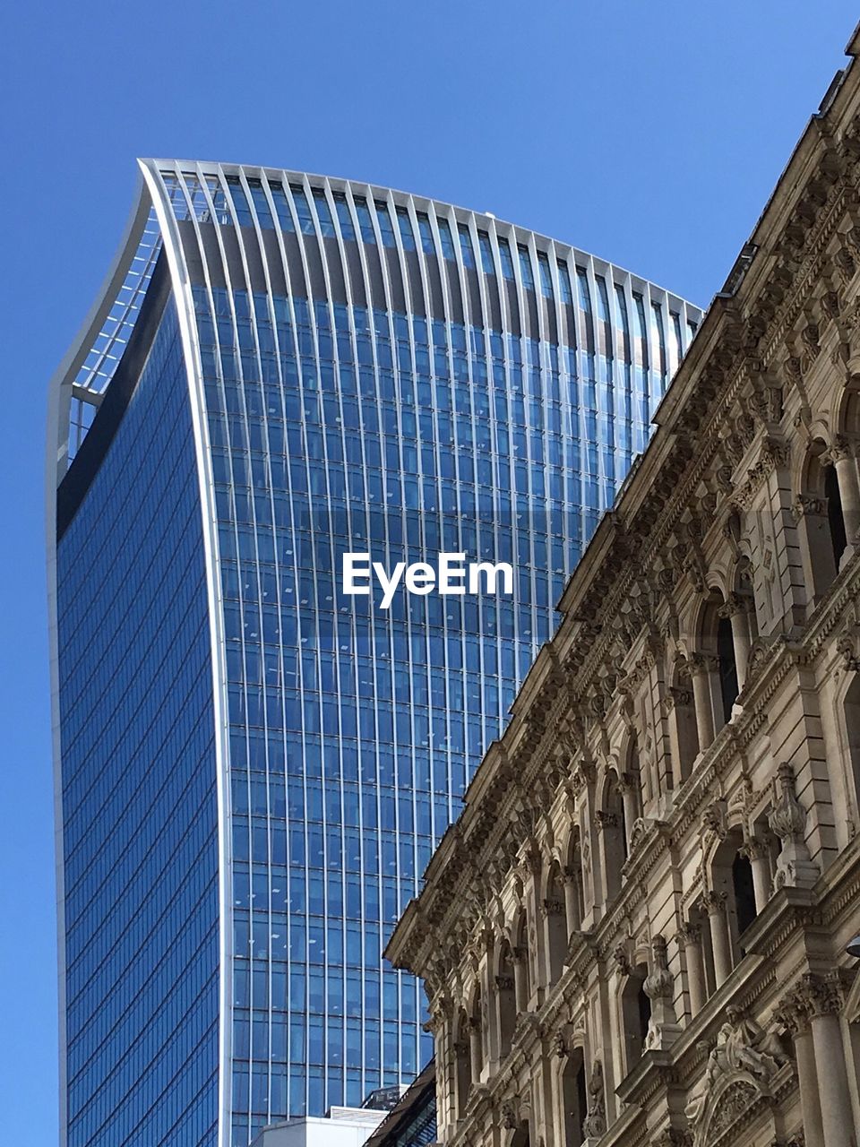 LOW ANGLE VIEW OF BUILDING AGAINST CLEAR BLUE SKY