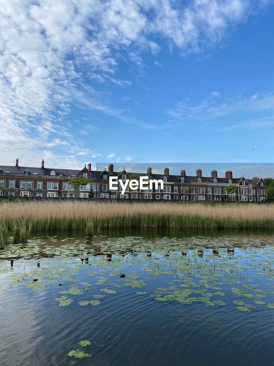 Scenic view of lake by building against sky