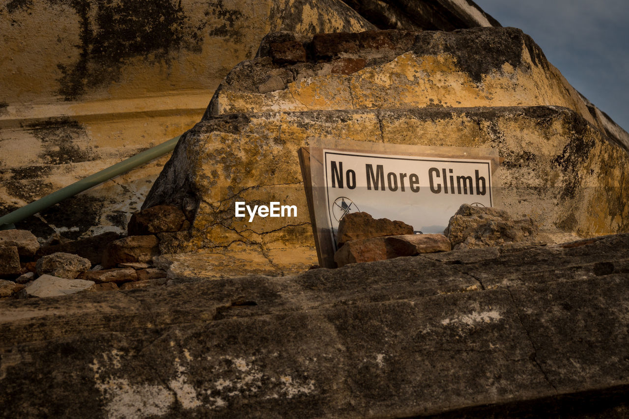 Warning sign on rock formation