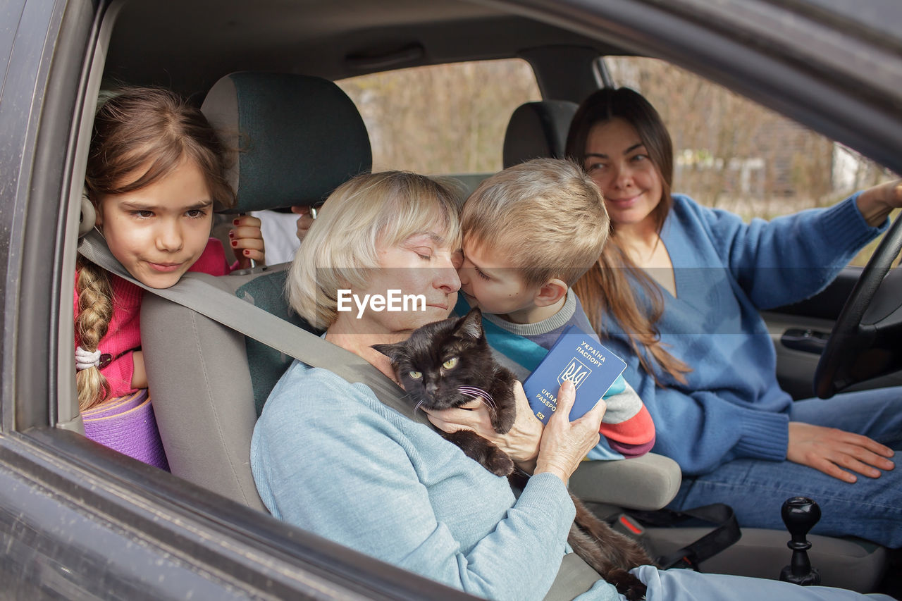 Ukrainian refugees flee from russian invasion, cross board by car together with pet, seek protection