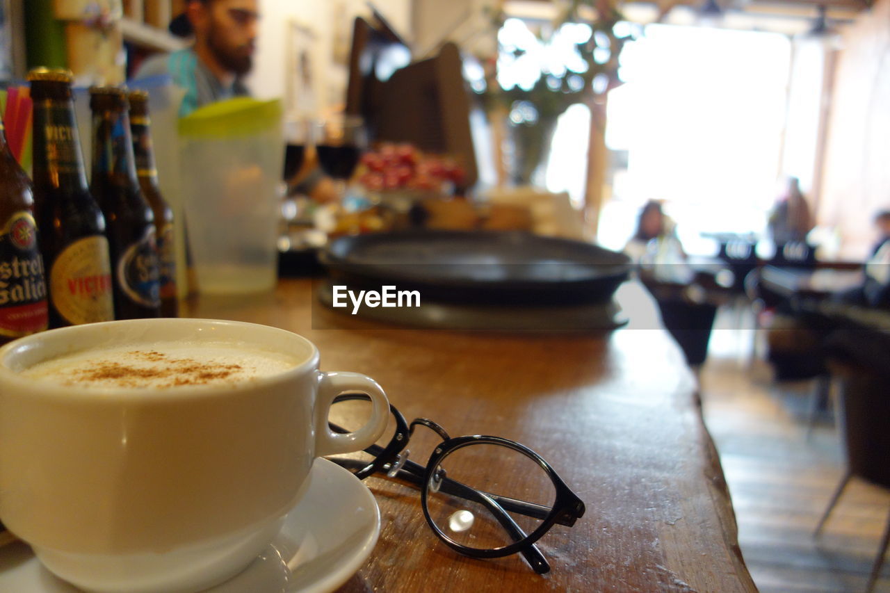 CLOSE-UP OF CAPPUCCINO ON TABLE