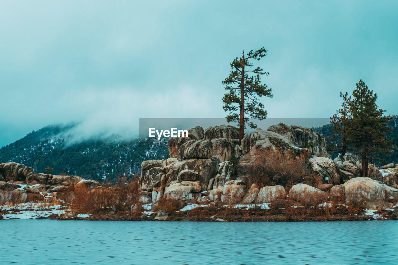 Scenic view of lake against sky during winter