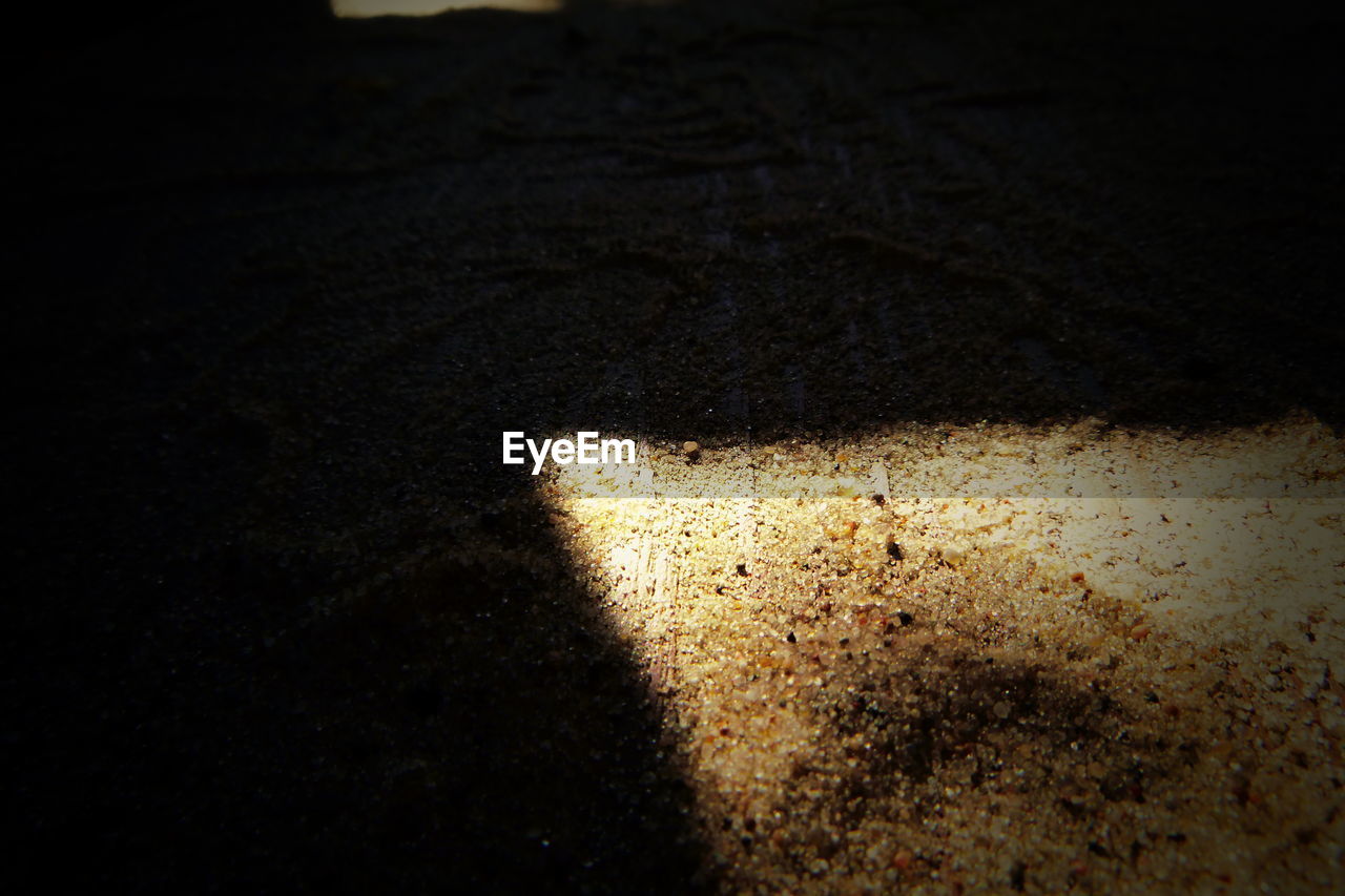 CLOSE-UP OF SHADOW ON SAND