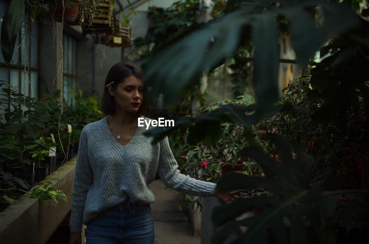 Woman standing amidst plants