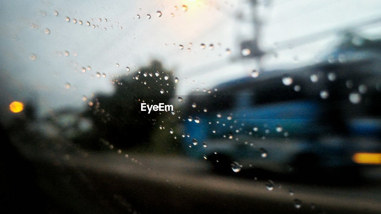 VIEW OF ILLUMINATED WINDOW AGAINST SKY SEEN THROUGH CAR WINDOWS