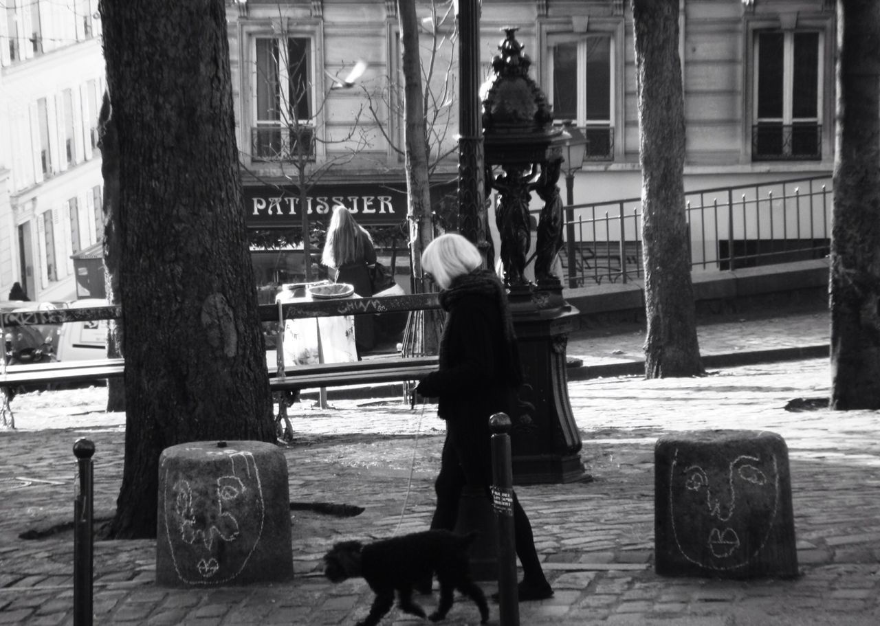 WOMAN STANDING ON CITY STREET