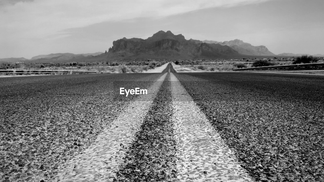 Surface level of road on field against sky