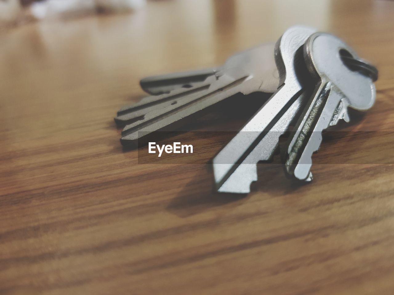 HIGH ANGLE VIEW OF KEYS ON WOODEN TABLE