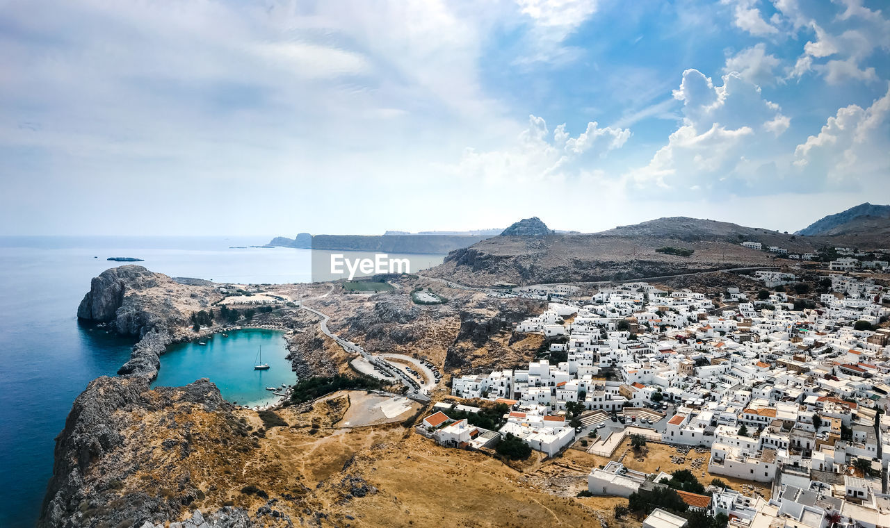 High angle view of townscape of lindos by sea against sky