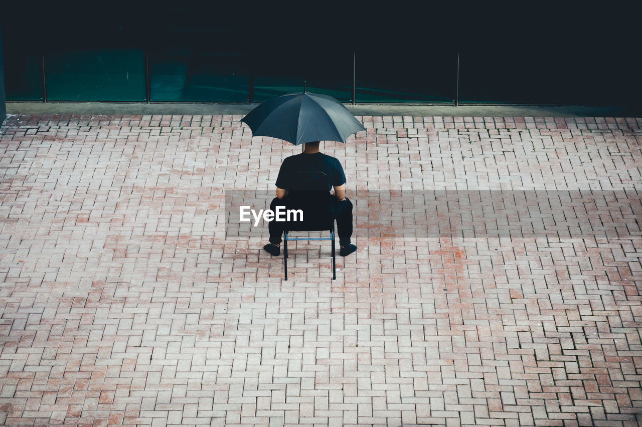 Rear view of man sitting outdoors