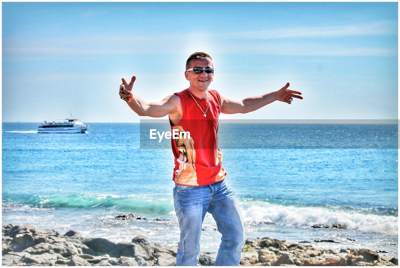 Smiling man standing at beach