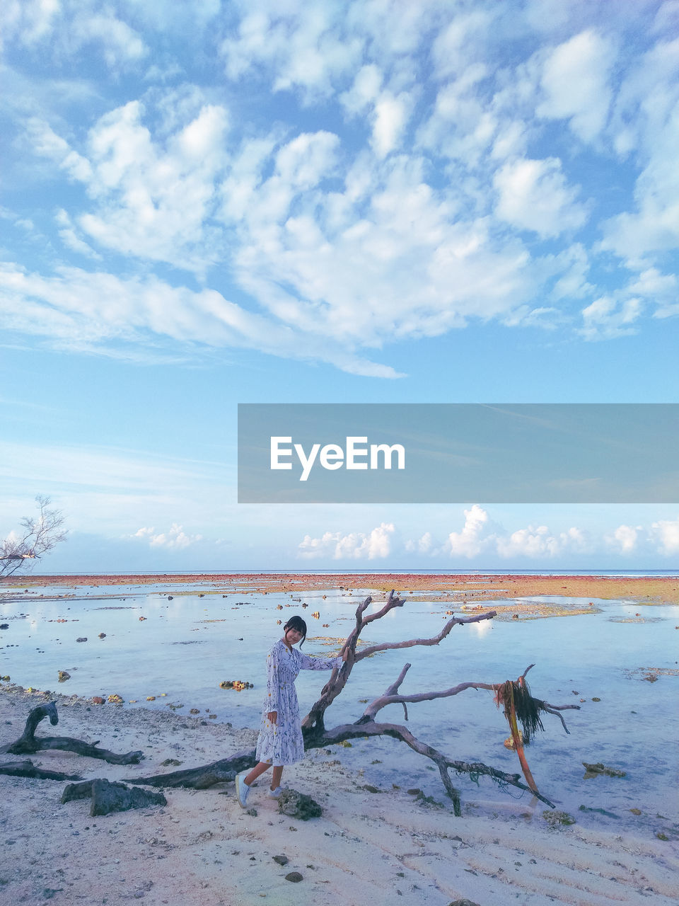 Woman on beach against sky