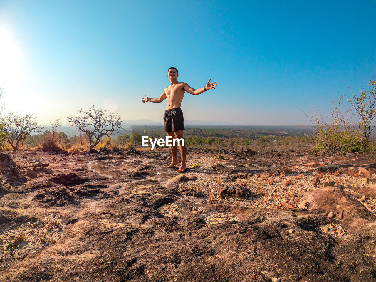 Full length of man standing on field against sky