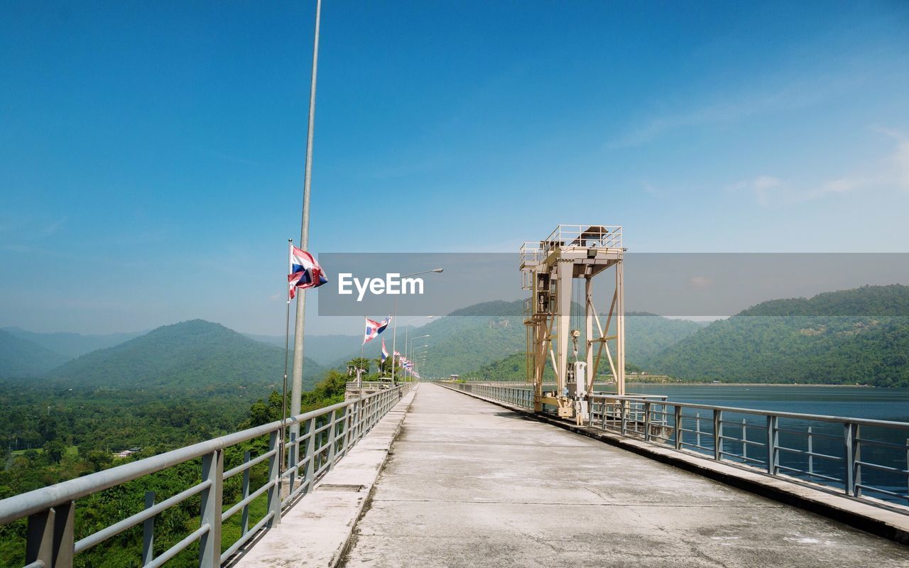 BRIDGE OVER MOUNTAINS AGAINST SKY