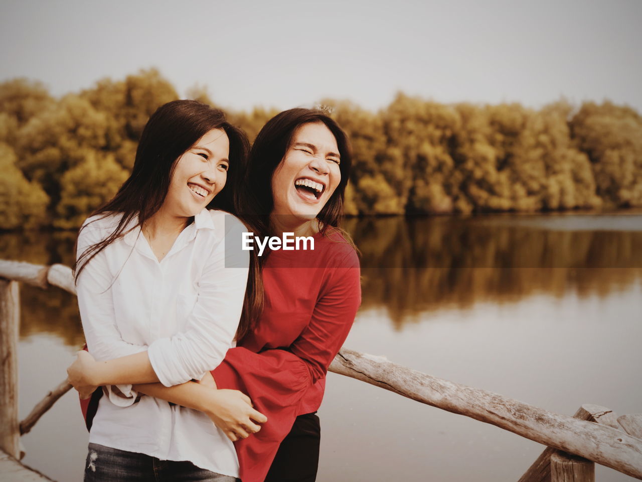 Portrait of smiling young women against sky