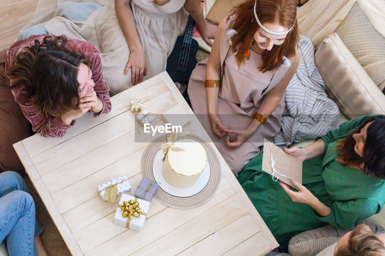 High angle view of people sitting on sofa