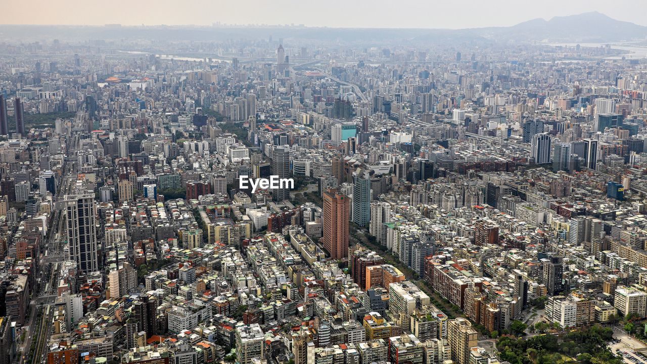 Aerial view of modern buildings in city against sky