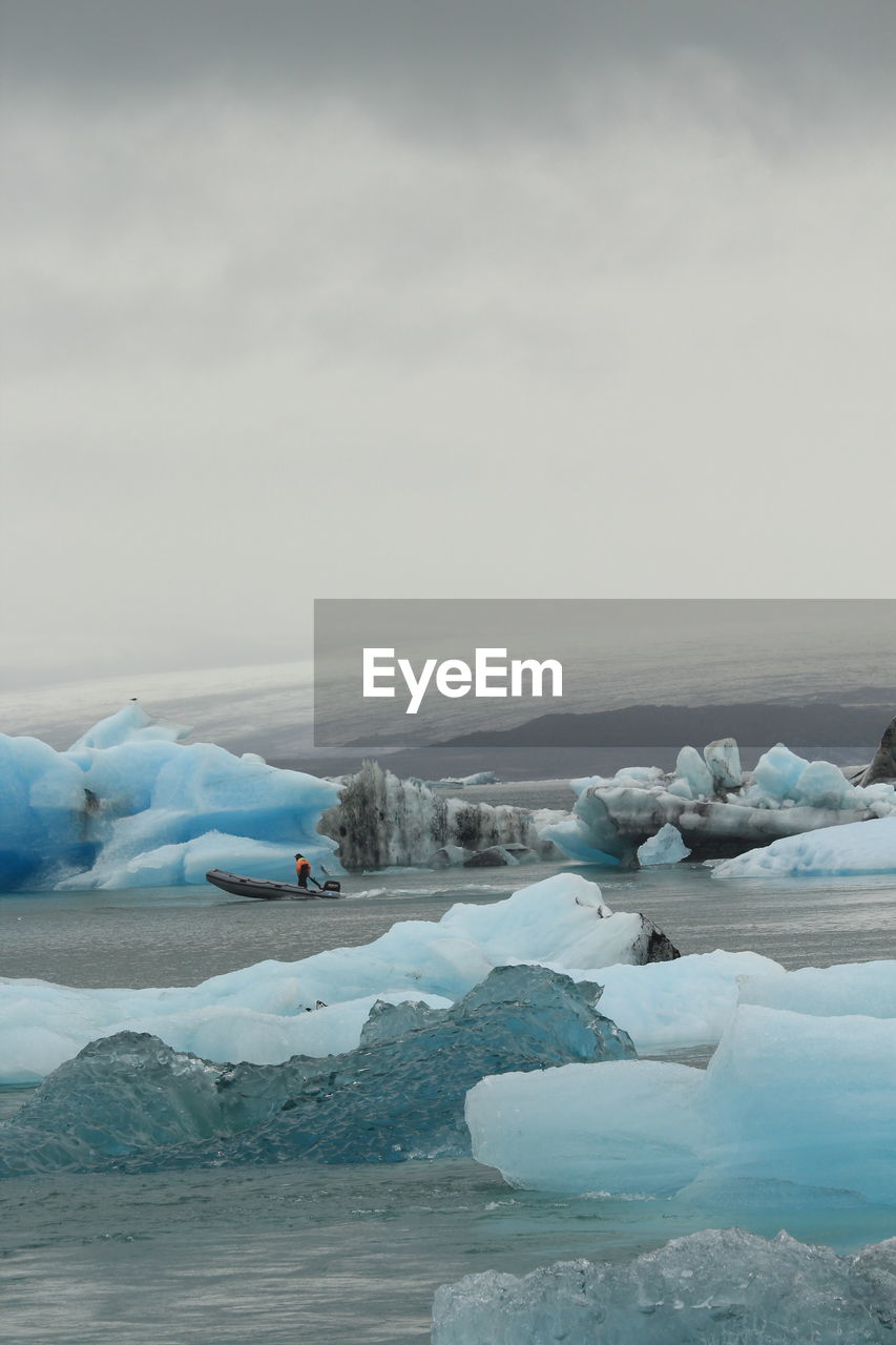 FROZEN LAKE AGAINST SKY