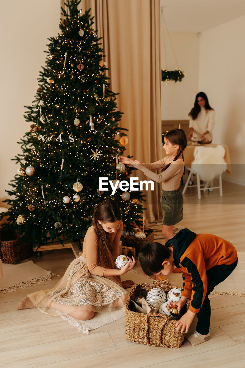 Family lifestyle. mom and kids are preparing for the christmas holidays in decorated house in winter