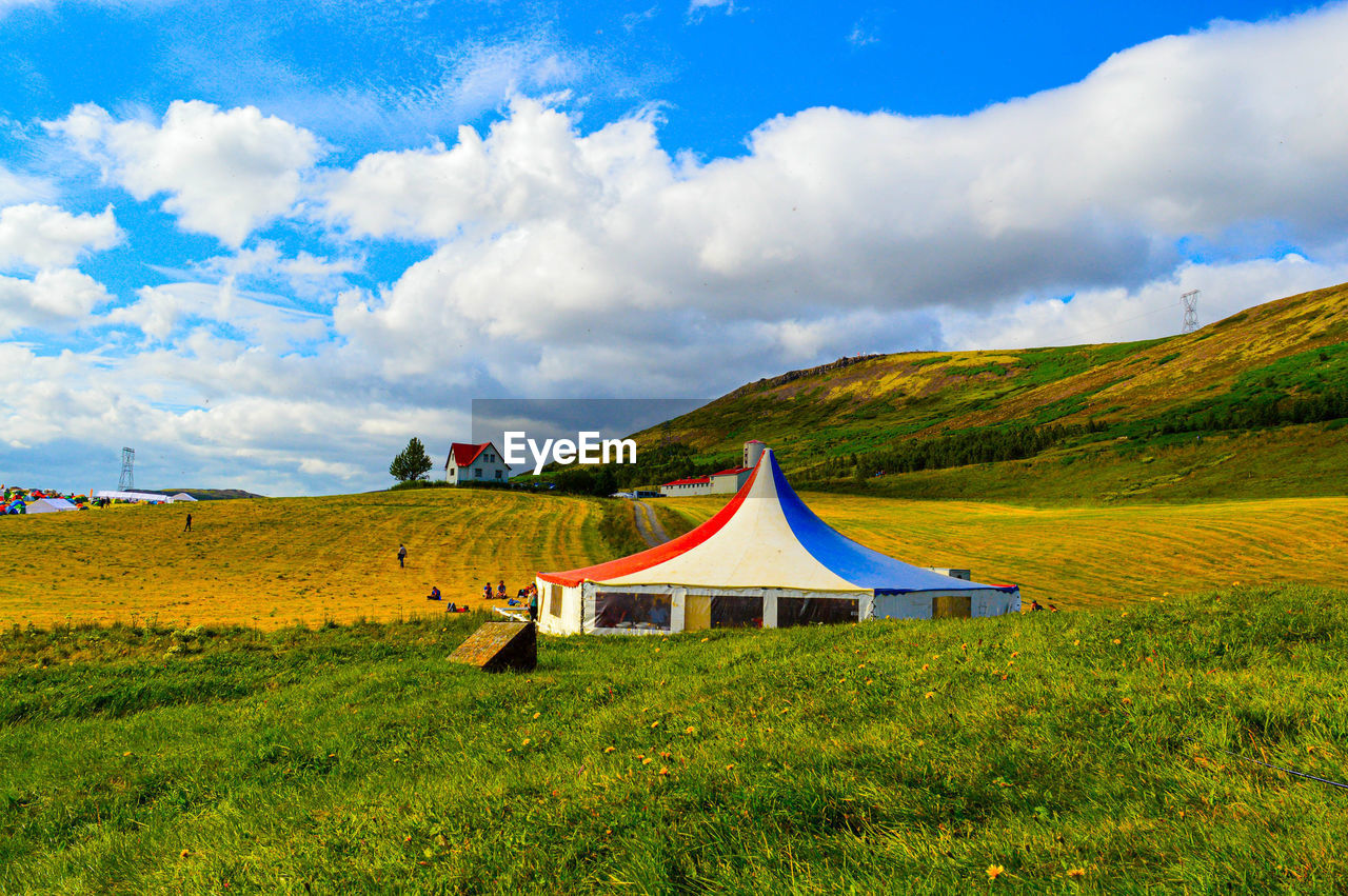 Tent on field against sky