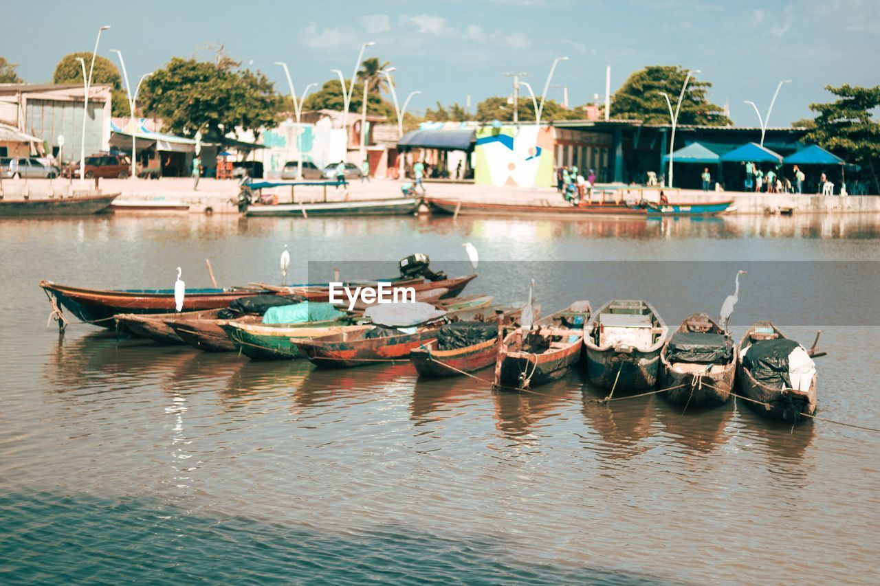 BOATS MOORED AT HARBOR