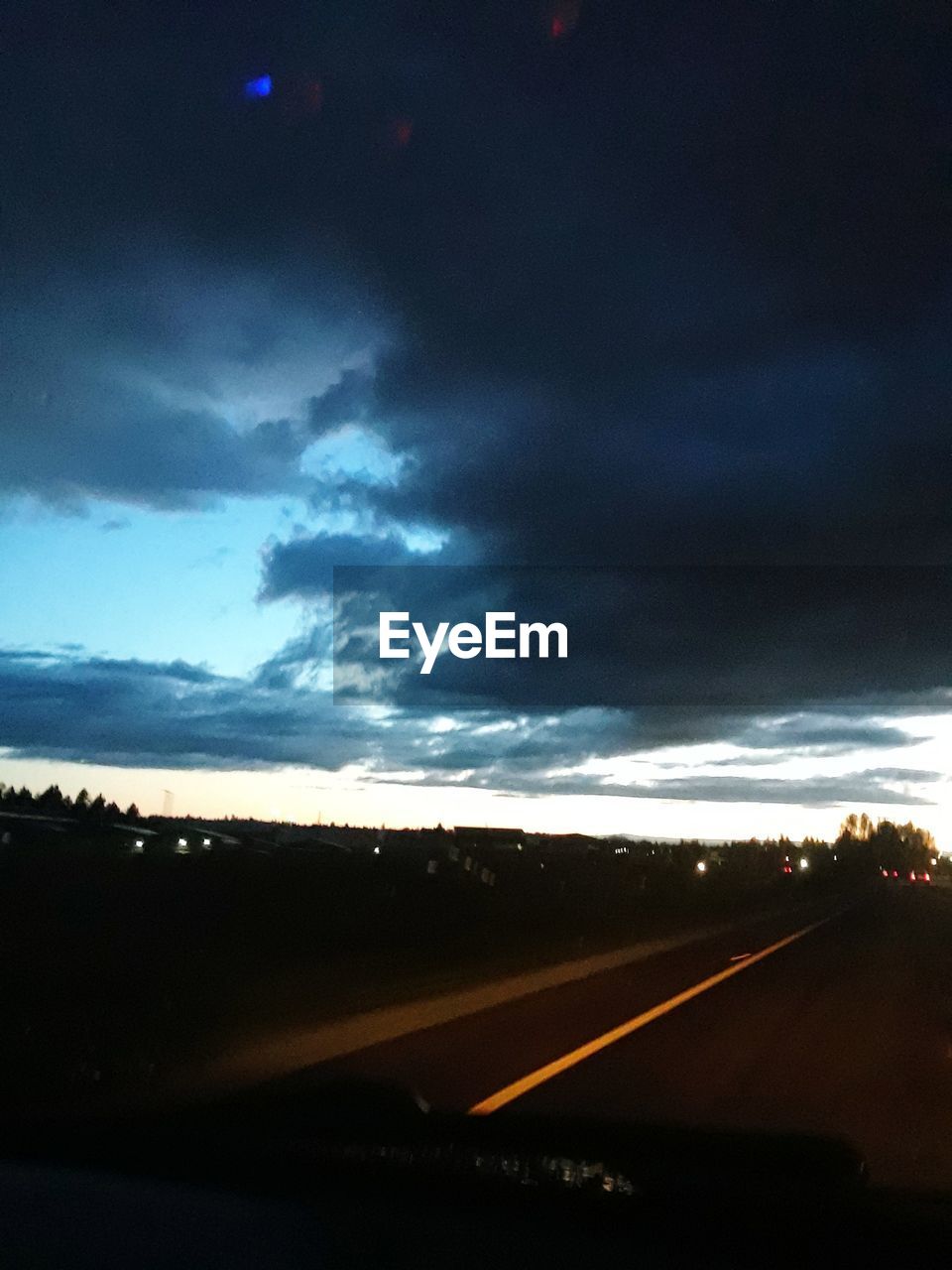 VIEW OF ROAD AGAINST CLOUDY SKY