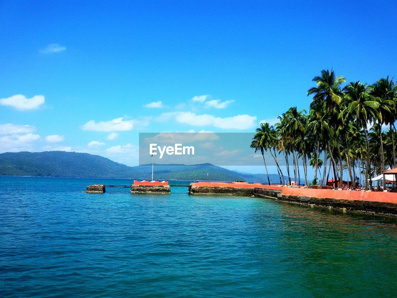 BOAT SAILING ON SEA AGAINST BLUE SKY